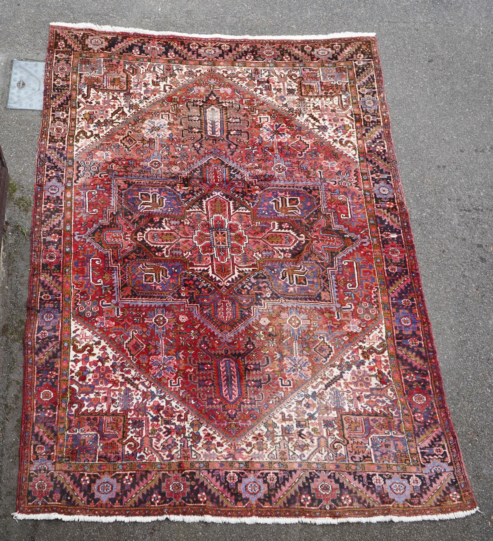 A Heriz brick red ground carpet